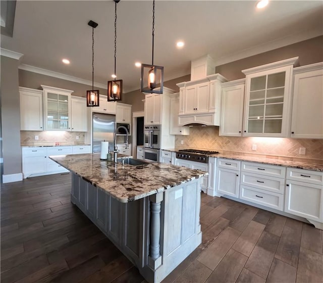 kitchen with appliances with stainless steel finishes, backsplash, sink, and white cabinetry