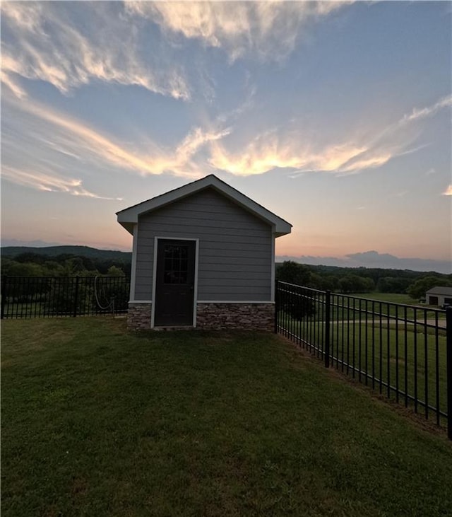 outdoor structure at dusk with a yard