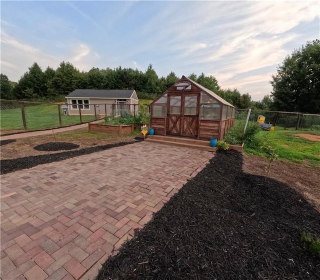 exterior space featuring a front lawn and an outbuilding