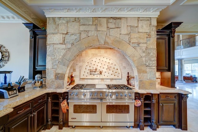 kitchen featuring double oven range, crown molding, decorative backsplash, dark brown cabinets, and light stone counters