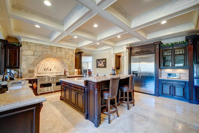 595 S Mount Carmel Rd, Mcdonough, GA 30253 - kitchen with premium appliances, a kitchen breakfast bar, a center island, beam ceiling, and coffered ceiling