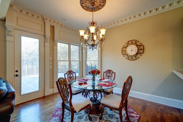 dining area with a notable chandelier and dark hardwood / wood-style floors