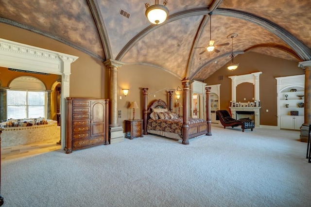 595 S Mount Carmel Rd, Mcdonough, GA 30253 - carpeted bedroom featuring ornate columns, vaulted ceiling, a fireplace, and arched walkways