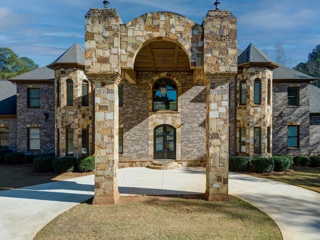 595 S Mount Carmel Rd, Mcdonough, GA 30253 - view of front of home with french doors, a chimney, stone siding, and brick siding