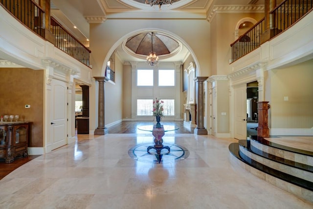 595 S Mount Carmel Rd, Mcdonough, GA 30253 - foyer entrance featuring a chandelier, a high ceiling, ornate columns, crown molding, and marble tiled flooring
