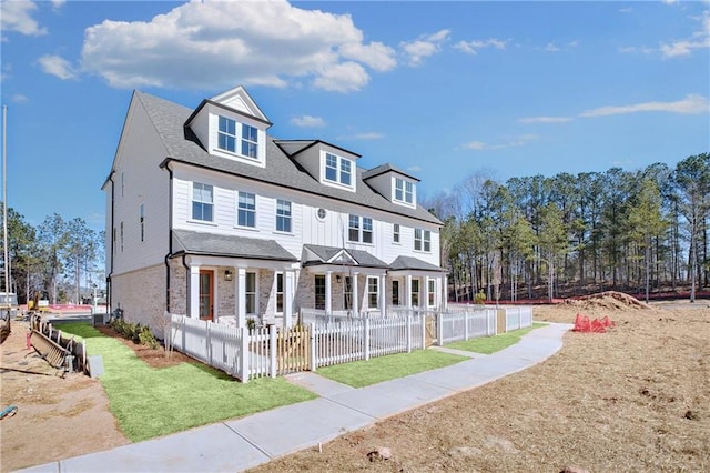 view of front of house featuring a patio area and fence private yard