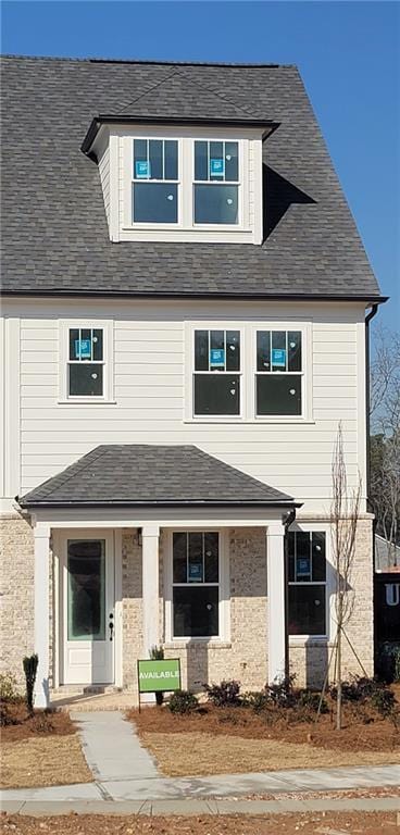 view of front of property with roof with shingles