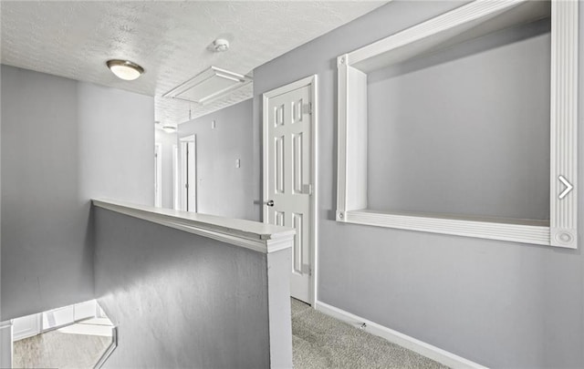 1332 Adcox Sq, Stone Mountain, GA 30088 - hall with attic access, a textured ceiling, carpet floors, and baseboards