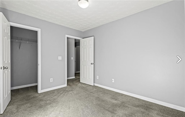 1332 Adcox Sq, Stone Mountain, GA 30088 - unfurnished bedroom featuring carpet flooring, baseboards, a closet, and a textured ceiling