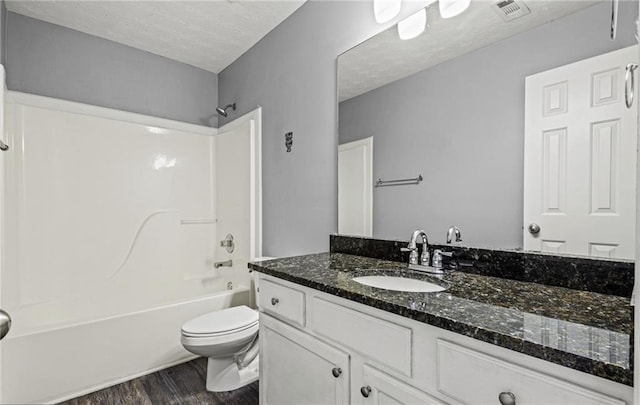 1332 Adcox Sq, Stone Mountain, GA 30088 - full bathroom featuring wood finished floors, bathtub / shower combination, vanity, toilet, and a textured ceiling