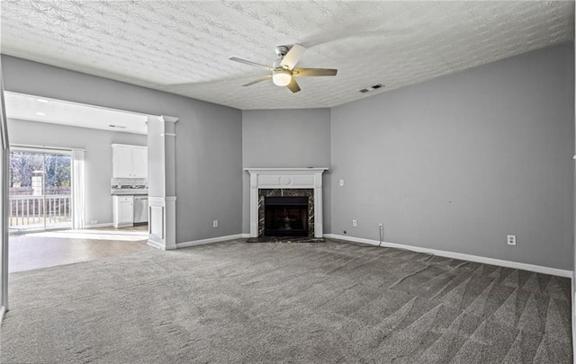 1332 Adcox Sq, Stone Mountain, GA 30088 - unfurnished living room featuring carpet, a ceiling fan, a premium fireplace, baseboards, and a textured ceiling