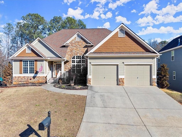 craftsman inspired home featuring an attached garage, stone siding, and concrete driveway