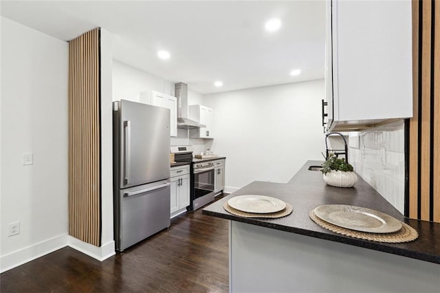 kitchen featuring sink, wall chimney exhaust hood, appliances with stainless steel finishes, dark hardwood / wood-style flooring, and white cabinetry