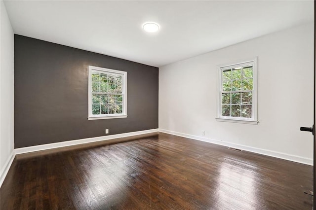 spare room with dark hardwood / wood-style floors