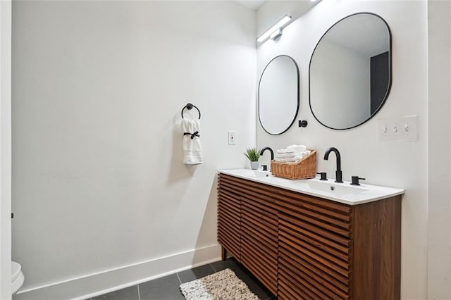 bathroom featuring tile patterned floors, vanity, and toilet