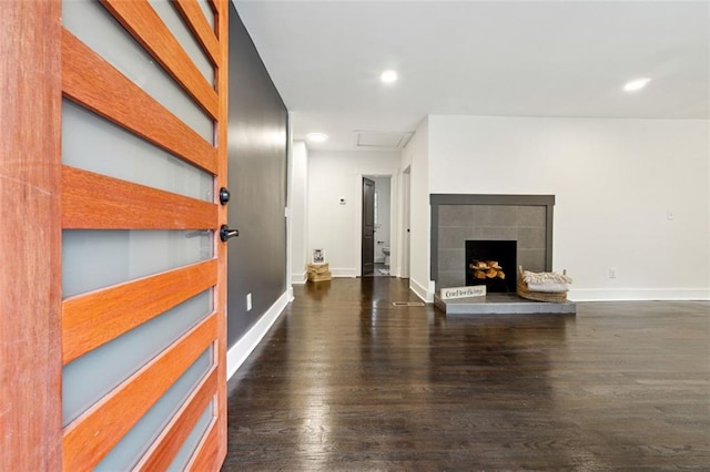 unfurnished living room featuring dark hardwood / wood-style flooring and a fireplace