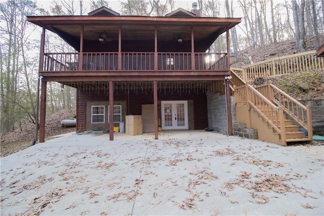 rear view of house with a wooden deck and french doors