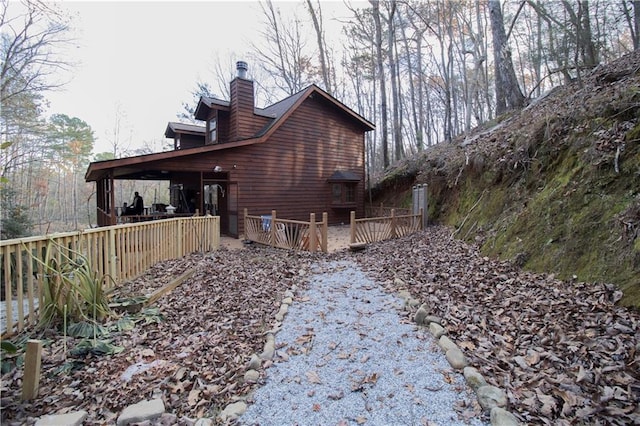 view of property exterior with a deck