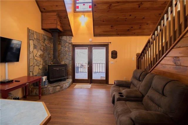 living room featuring wood-type flooring, a wood stove, french doors, and wooden ceiling