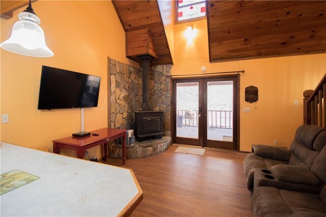 living room featuring wooden ceiling, a wood stove, high vaulted ceiling, french doors, and hardwood / wood-style flooring