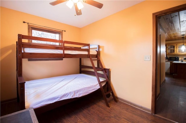 bedroom with ceiling fan and dark wood-type flooring