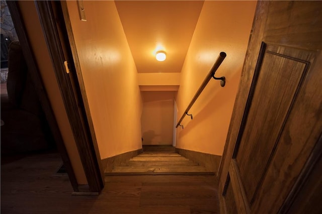 stairs featuring hardwood / wood-style flooring