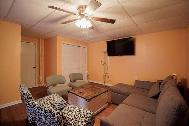 living room featuring a paneled ceiling, ceiling fan, and hardwood / wood-style floors