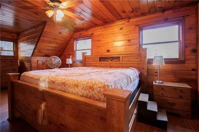 bedroom with dark hardwood / wood-style flooring, wood ceiling, vaulted ceiling, ceiling fan, and wood walls