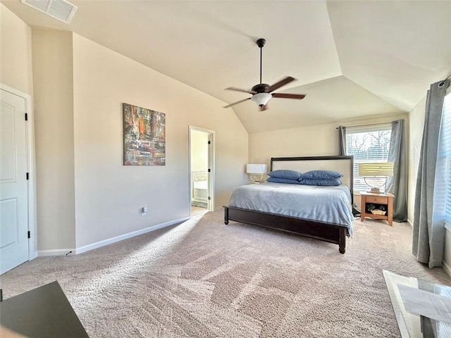 bedroom with visible vents, baseboards, carpet, vaulted ceiling, and ensuite bathroom