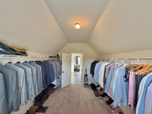 spacious closet with carpet and vaulted ceiling