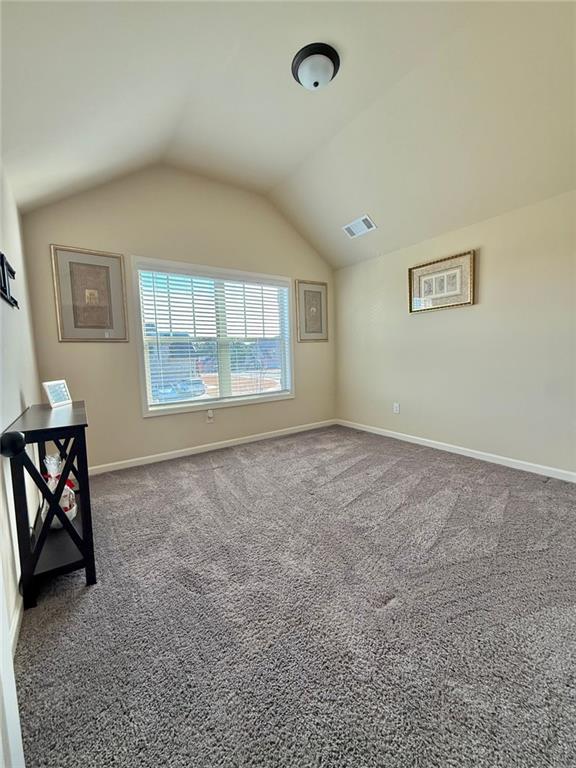 bonus room featuring vaulted ceiling, carpet, visible vents, and baseboards