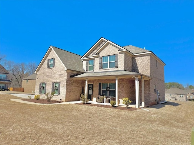 view of front of property with covered porch and brick siding