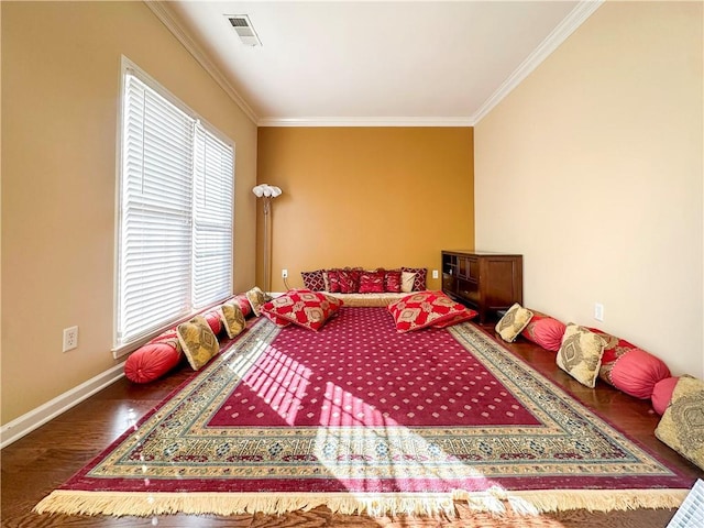 bedroom with ornamental molding and dark hardwood / wood-style flooring