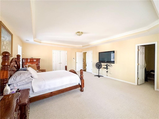 carpeted bedroom with a tray ceiling