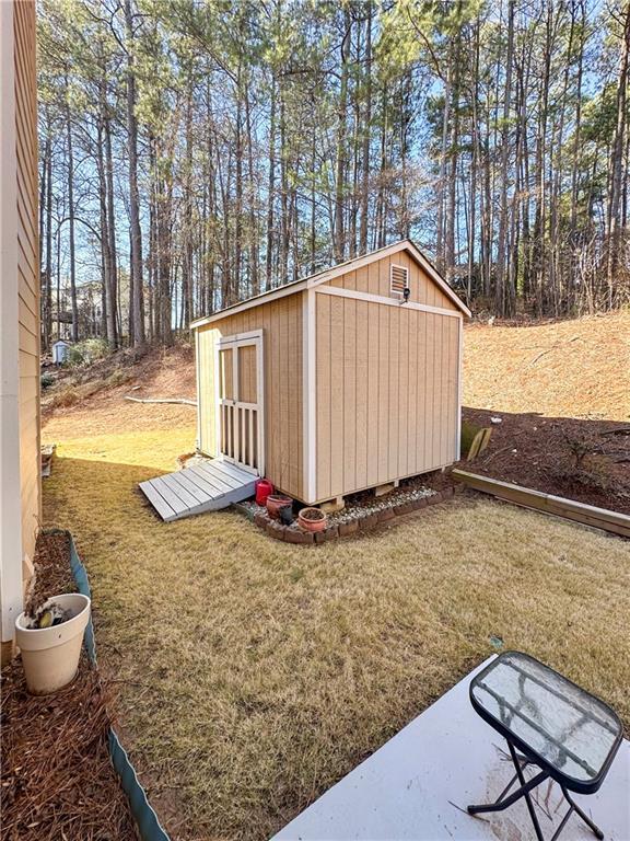 view of outbuilding featuring a lawn