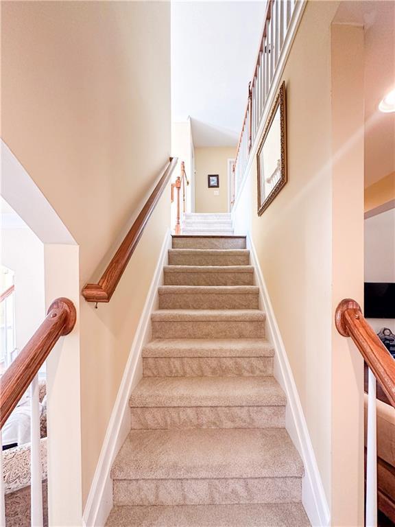 staircase with a towering ceiling