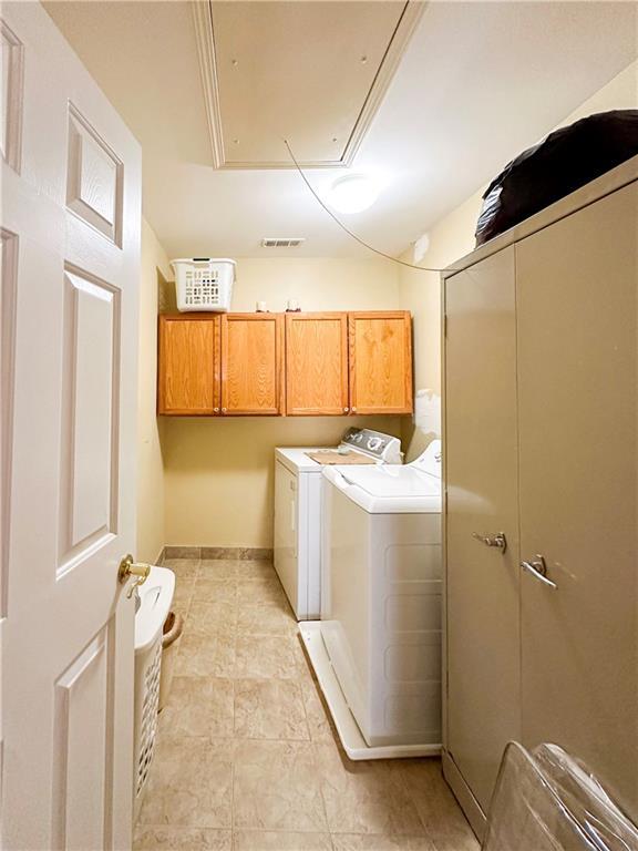 laundry area featuring cabinets and washer and clothes dryer