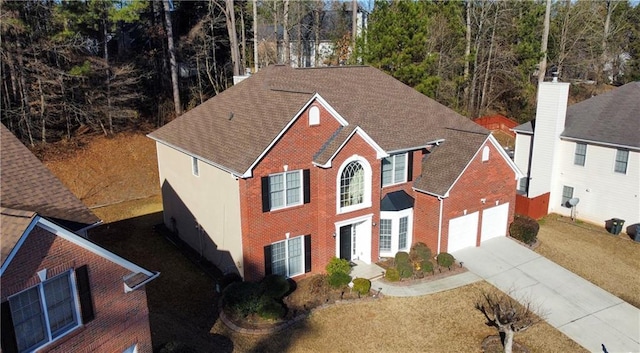 view of front of house featuring a garage and a front lawn