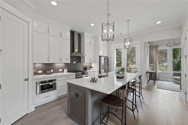 4200 Legacy Ln Unit 22, Acworth, GA 30101 - kitchen featuring wall chimney exhaust hood, appliances with stainless steel finishes, a chandelier, a center island with sink, and recessed lighting