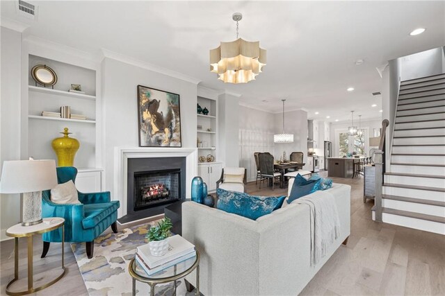 4200 Legacy Ln Unit 22, Acworth, GA 30101 - living room with a chandelier, stairway, a lit fireplace, light wood finished floors, and recessed lighting