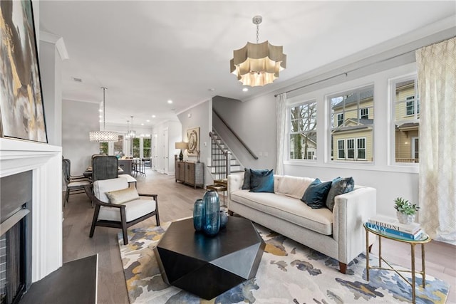 4200 Legacy Ln Unit 22, Acworth, GA 30101 - living area with a chandelier, a fireplace, stairway, wood finished floors, and ornamental molding