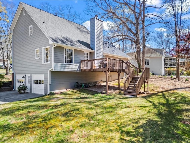 back of house with a chimney, a wooden deck, a garage, stairway, and a yard