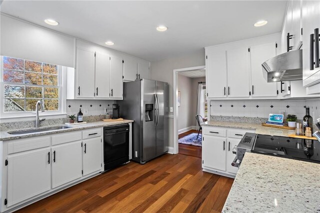 kitchen featuring ventilation hood, a sink, range with electric cooktop, black dishwasher, and stainless steel refrigerator with ice dispenser