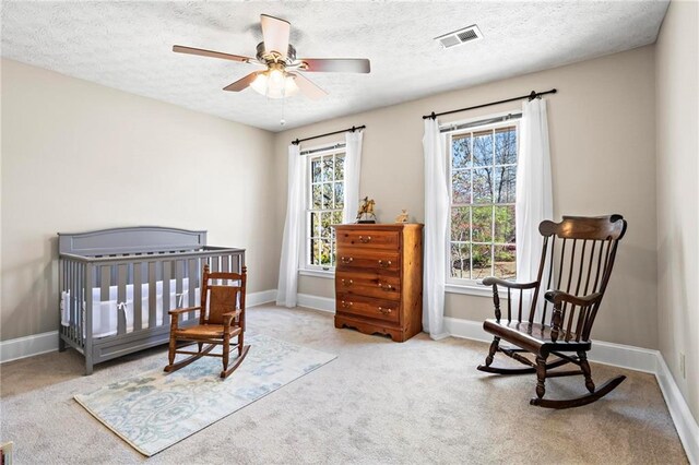 bedroom featuring baseboards, carpet, and a textured ceiling