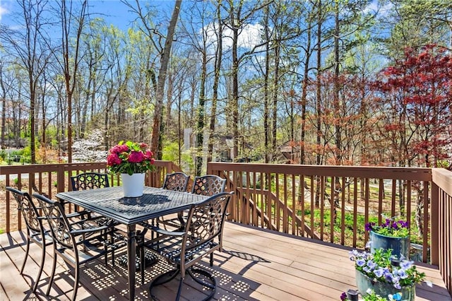 wooden terrace featuring outdoor dining space