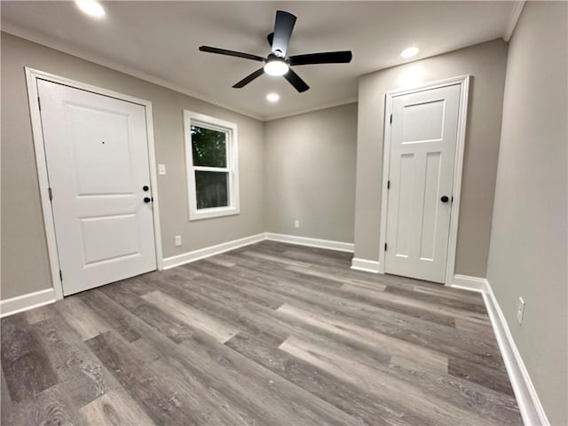 empty room featuring ornamental molding, ceiling fan, and dark hardwood / wood-style floors