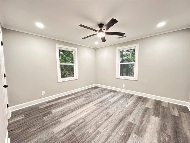 empty room with crown molding, ceiling fan, and hardwood / wood-style flooring