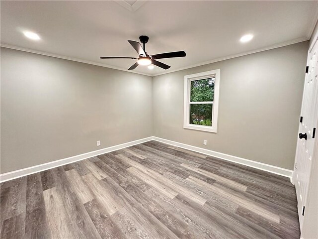 empty room with ceiling fan, hardwood / wood-style flooring, and crown molding