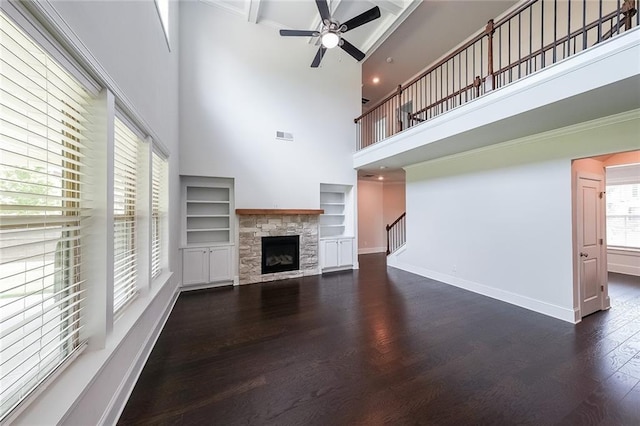 5789 Creek Indian Dr, Sugar Hill, GA 30518 - unfurnished living room featuring a high ceiling, dark wood-style floors, ceiling fan, a fireplace, and baseboards