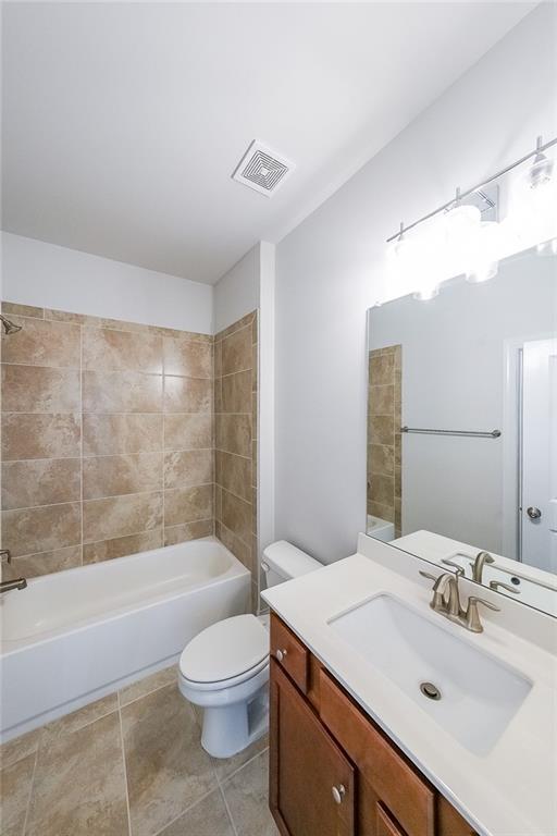 5789 Creek Indian Dr, Sugar Hill, GA 30518 - full bathroom featuring vanity, toilet, bathing tub / shower combination, and tile patterned floors